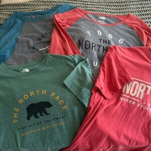 2 short sleeve, 1 long sleeve and 1 quarter sleeve The North Face shirts.